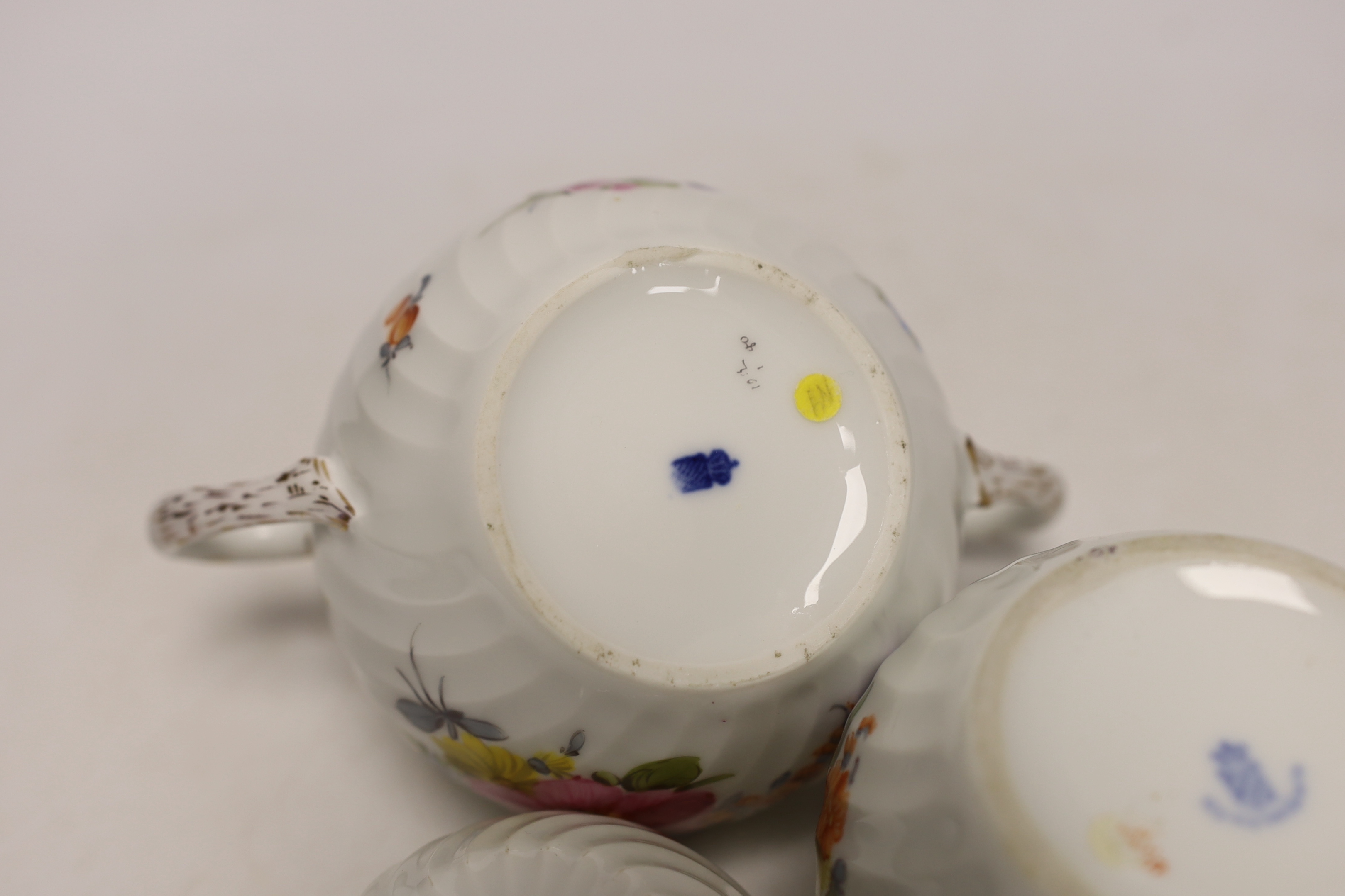 A Nymphenburg floral decorated teapot, milk jug and sugar bowl, teapot 13c high